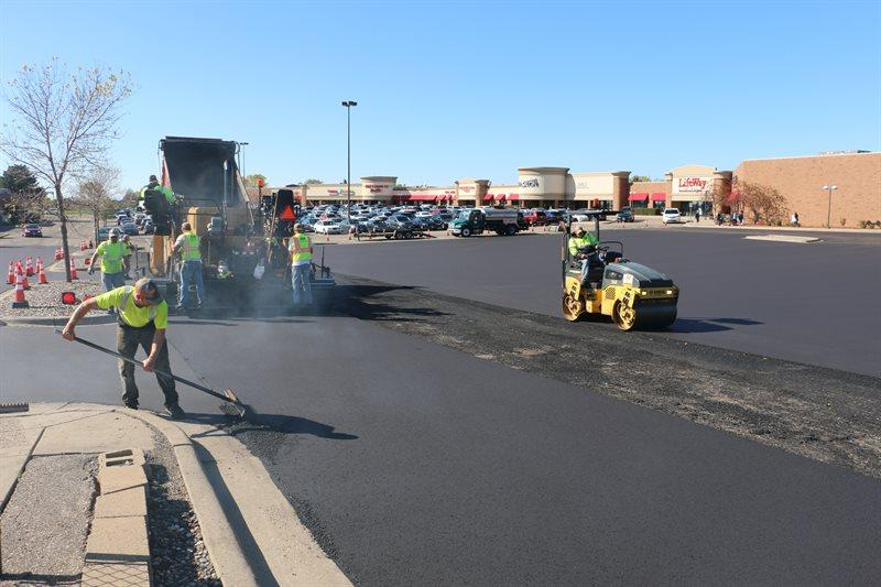 Commercial asphalt paving crew installing a parking lot
